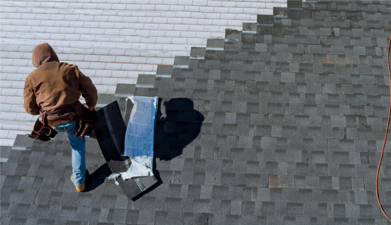 Man putting on shingles