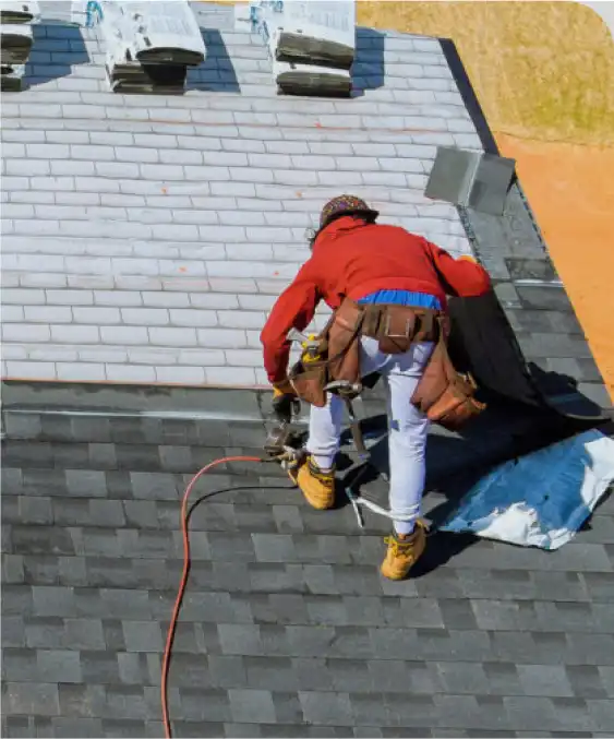 Man putting on shingle roof